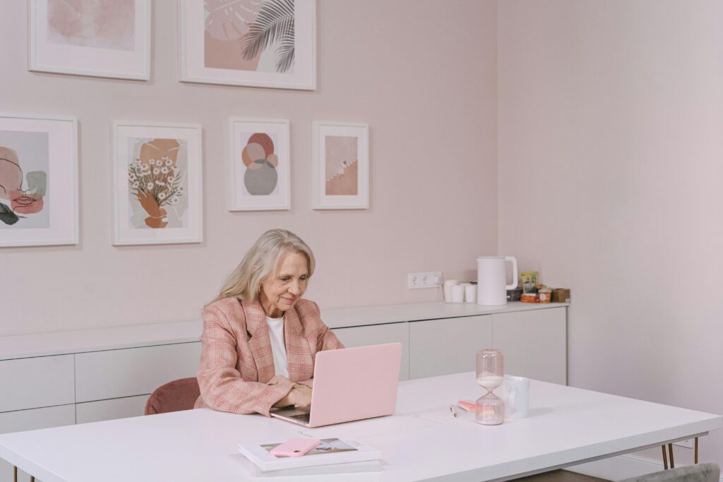 woman in pink suit working on her pink computer