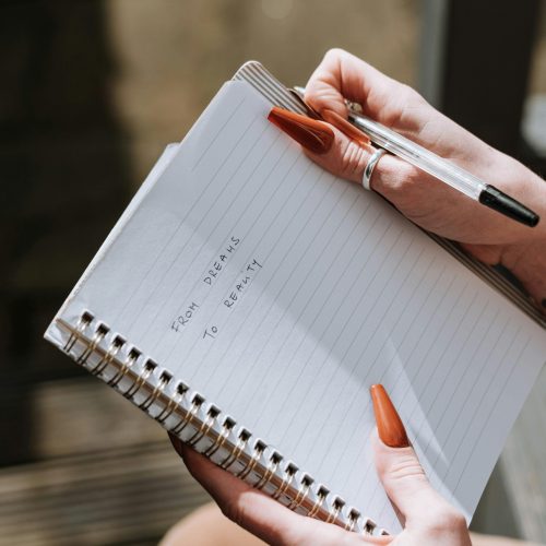 Your dreams into reality written on a notebook